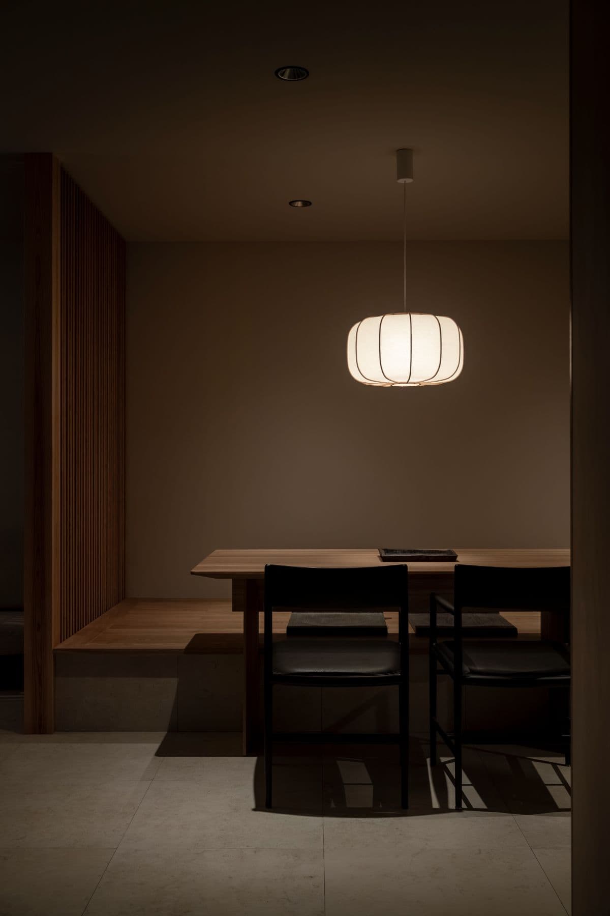 Japanese-modern dining under a paper lantern