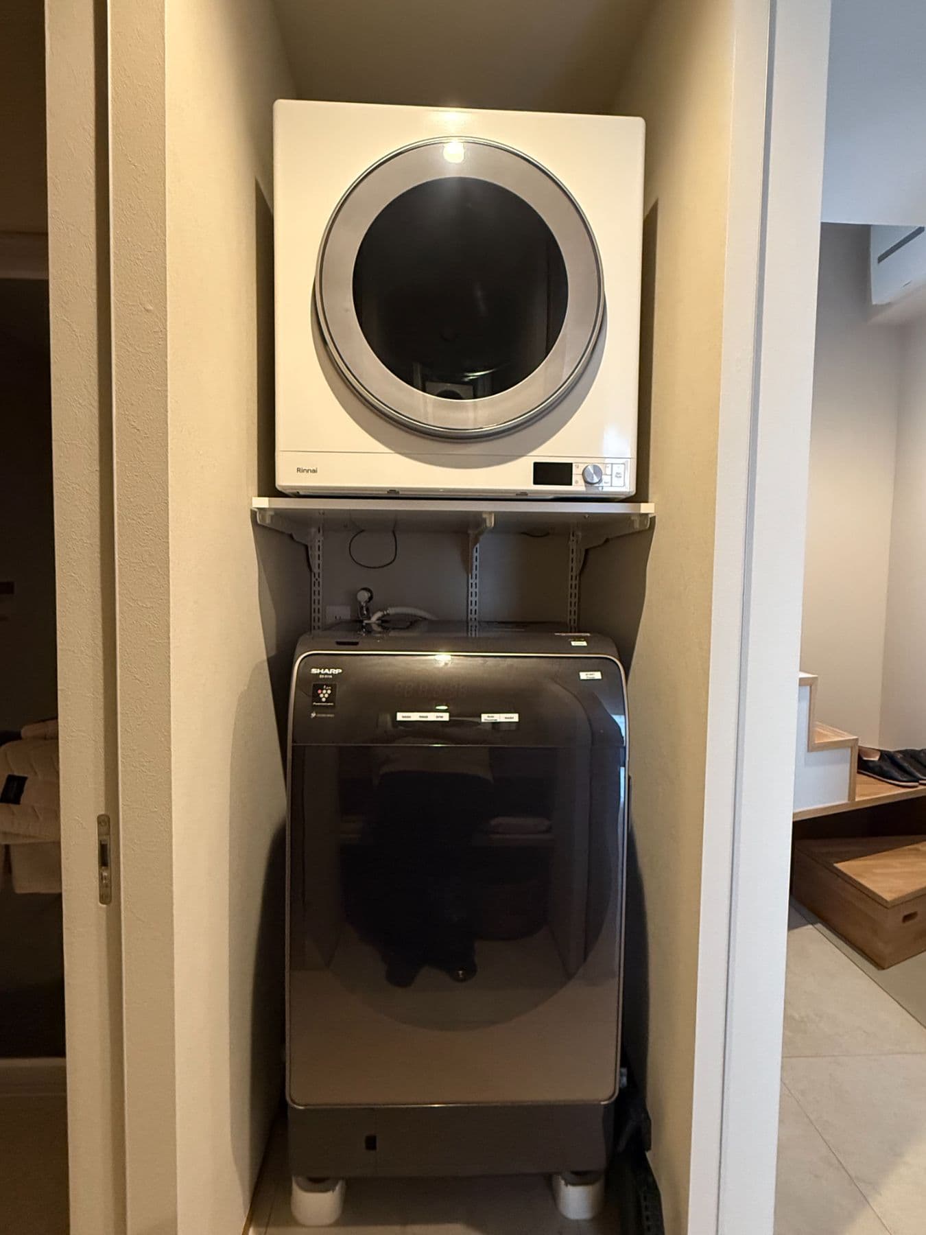 A laundry space with a drum washing machine and gas dryer, convenient for longer stays.